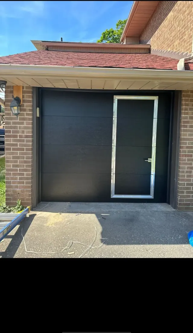 Black garage door with pedestrian door – Garagetex project photo
